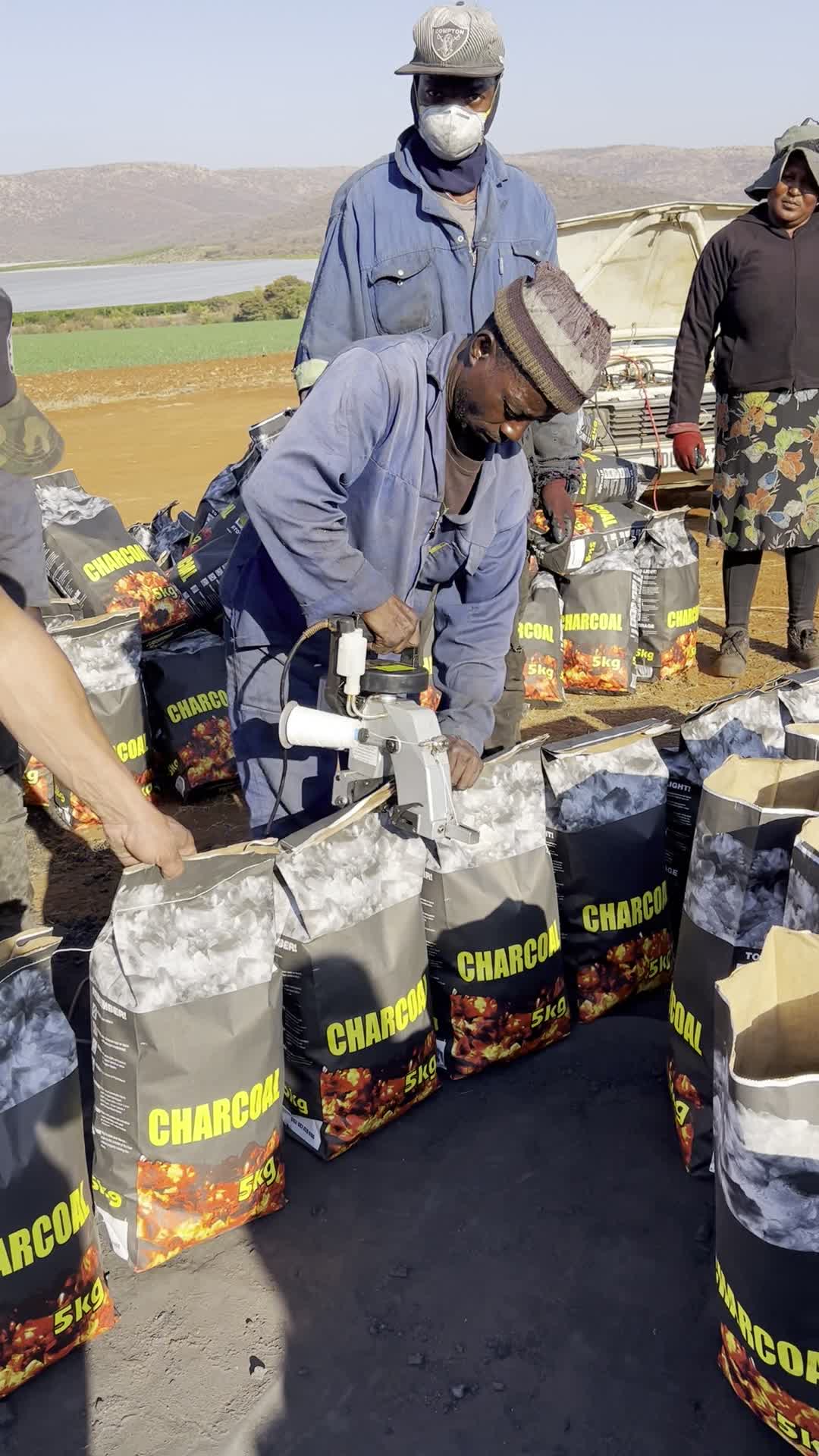 Loskop Charcoal team sealing freshly packed charcoal bags